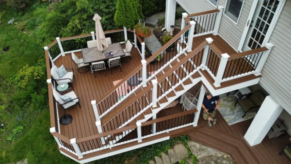 Custom deck design by VM Power Deck featuring a multi-level structure with built-in seating and ambient lighting