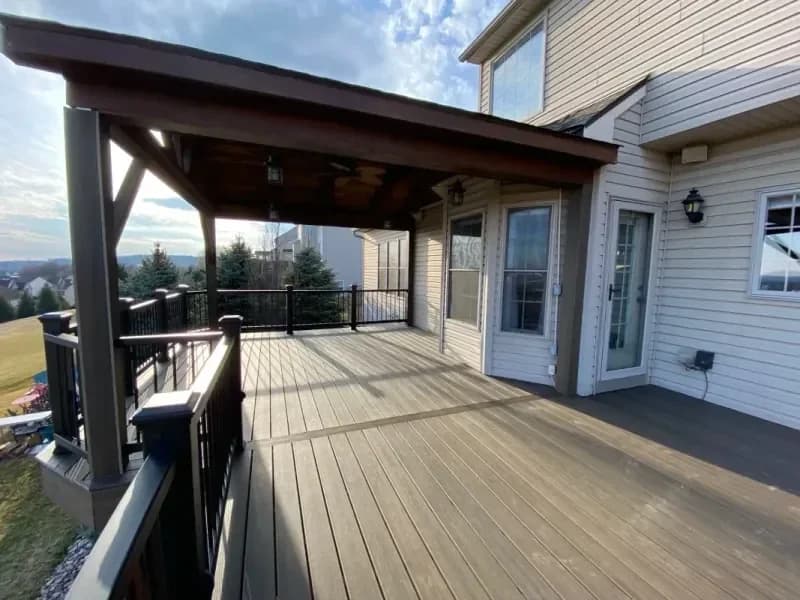 Covered deck with timber ceiling and black railing
