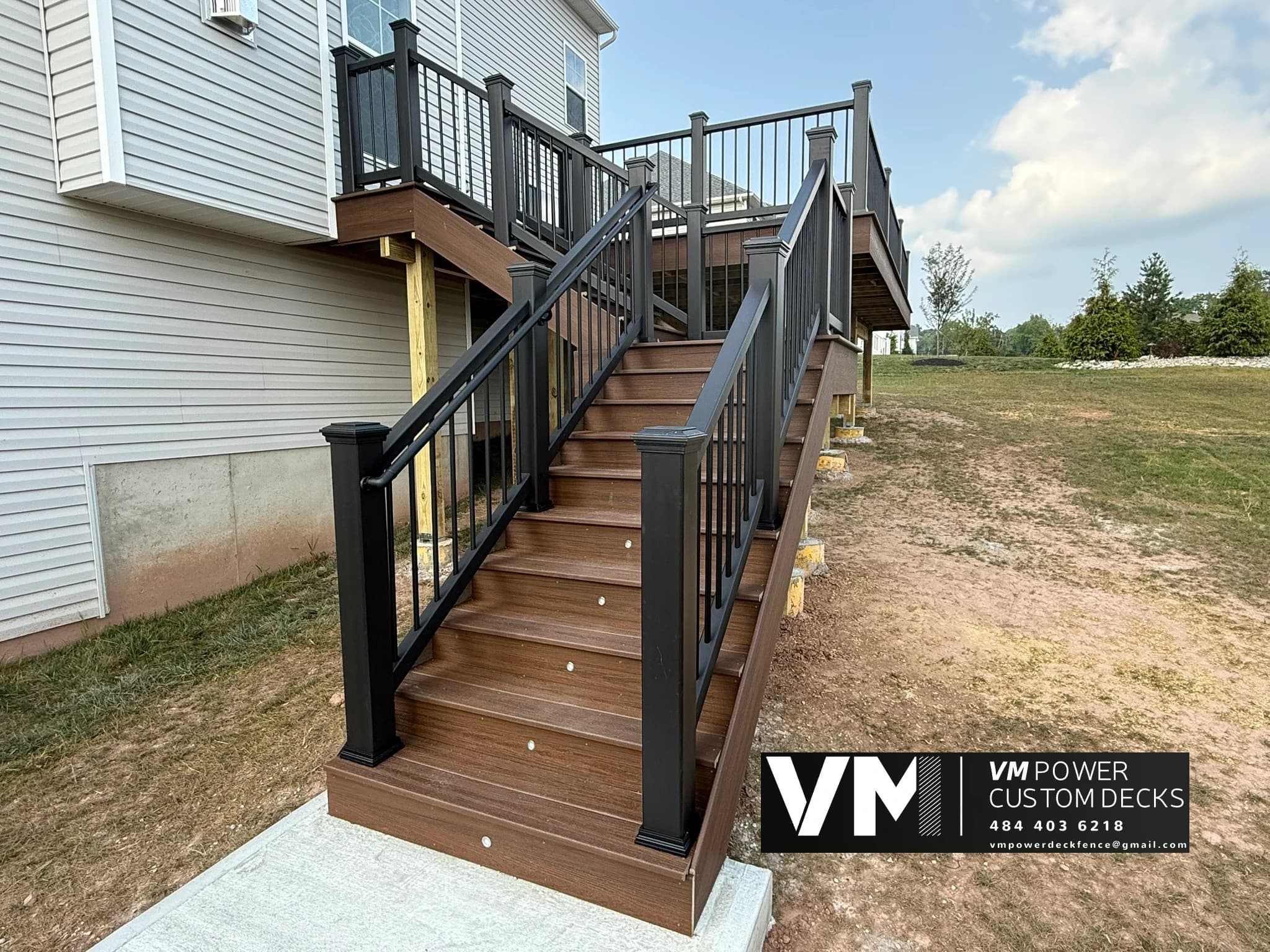 Finished deck stairs with black railing and integrated riser lights