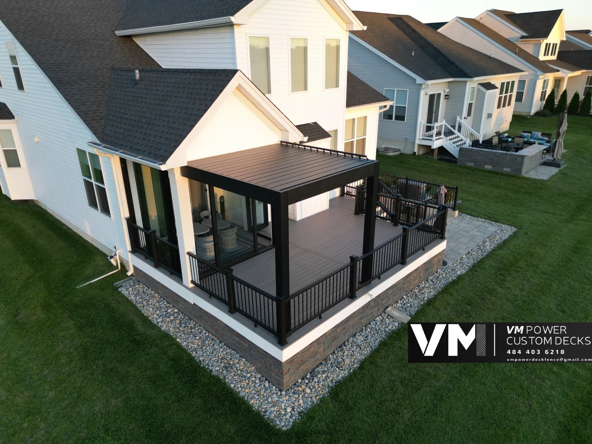 Motorized aluminum louvered pergola over a Trex deck with black railing in Bath, PA