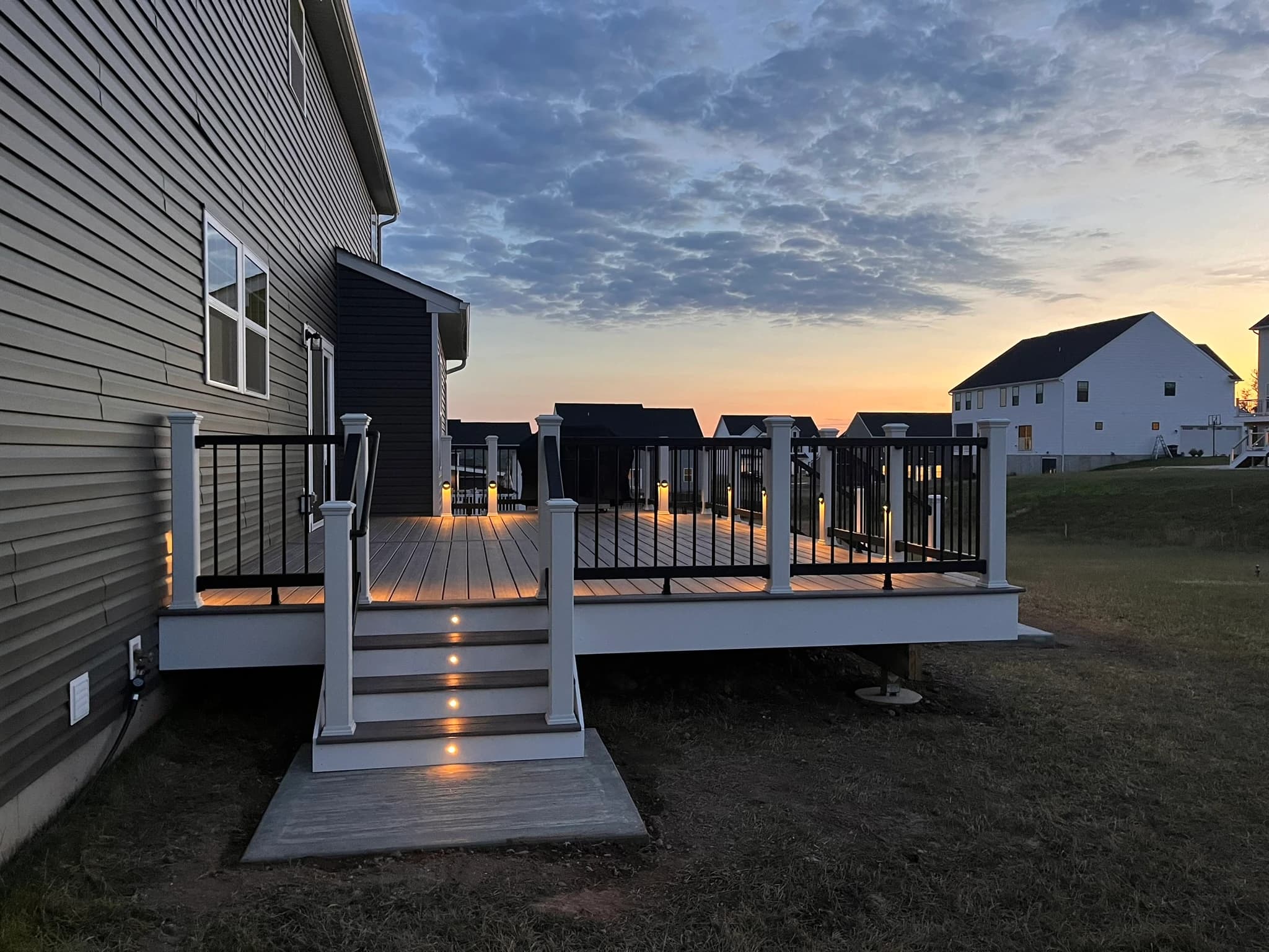 Stair lighting and contrasting white fascia at dusk.