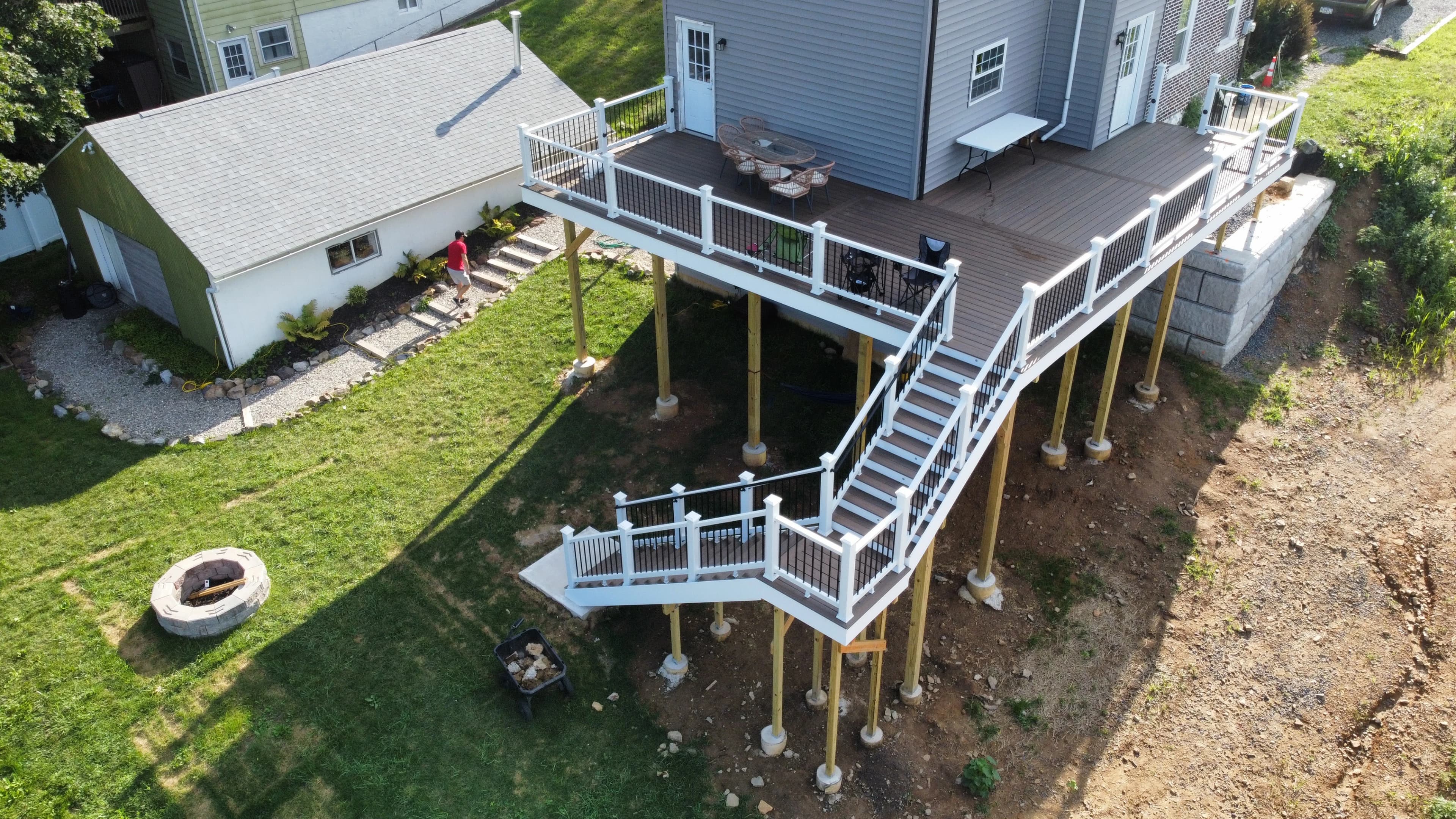 Elevated deck and stair route beside the sloping yard.