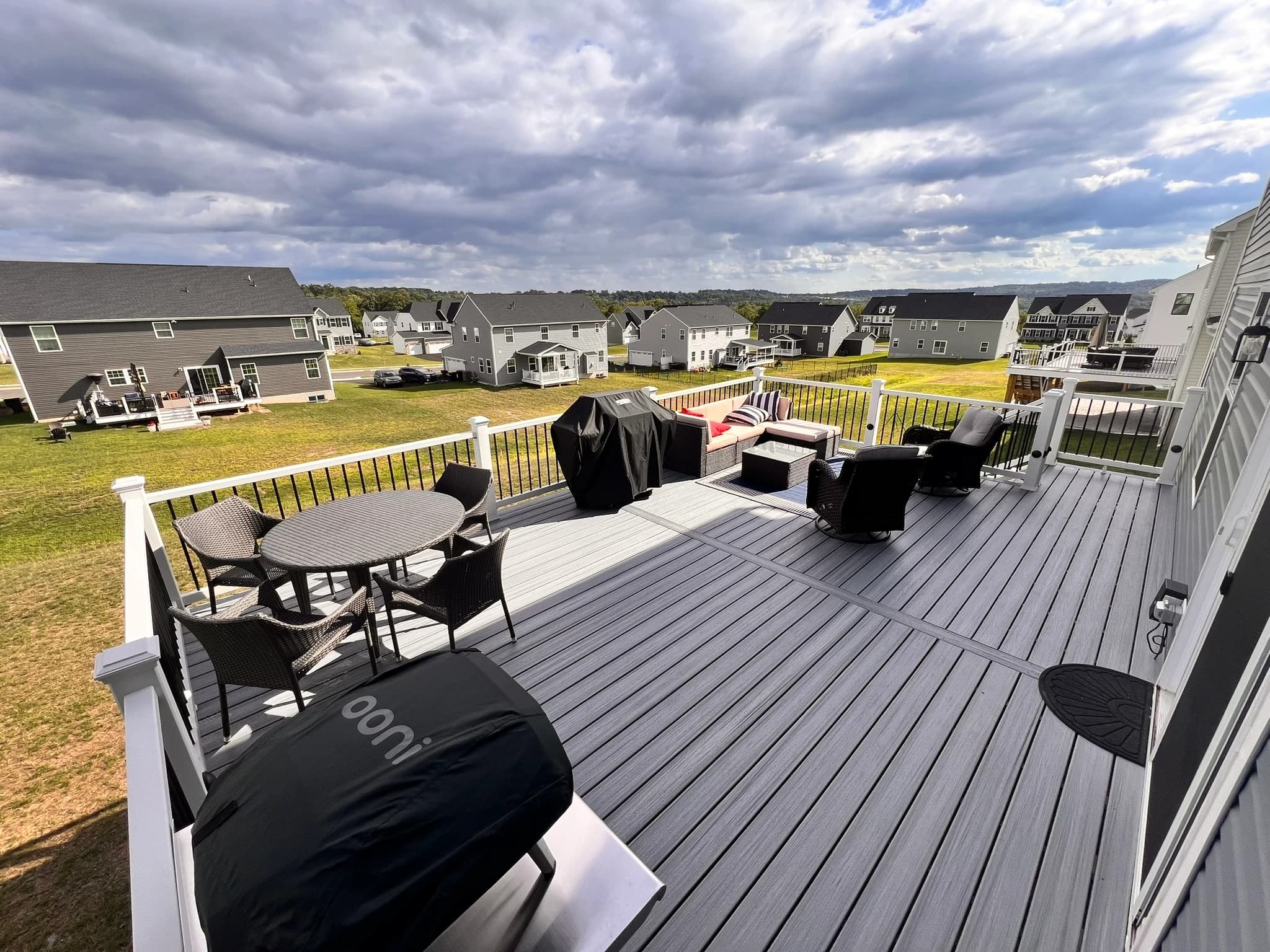 Upper deck with lounge seating and a dining table.