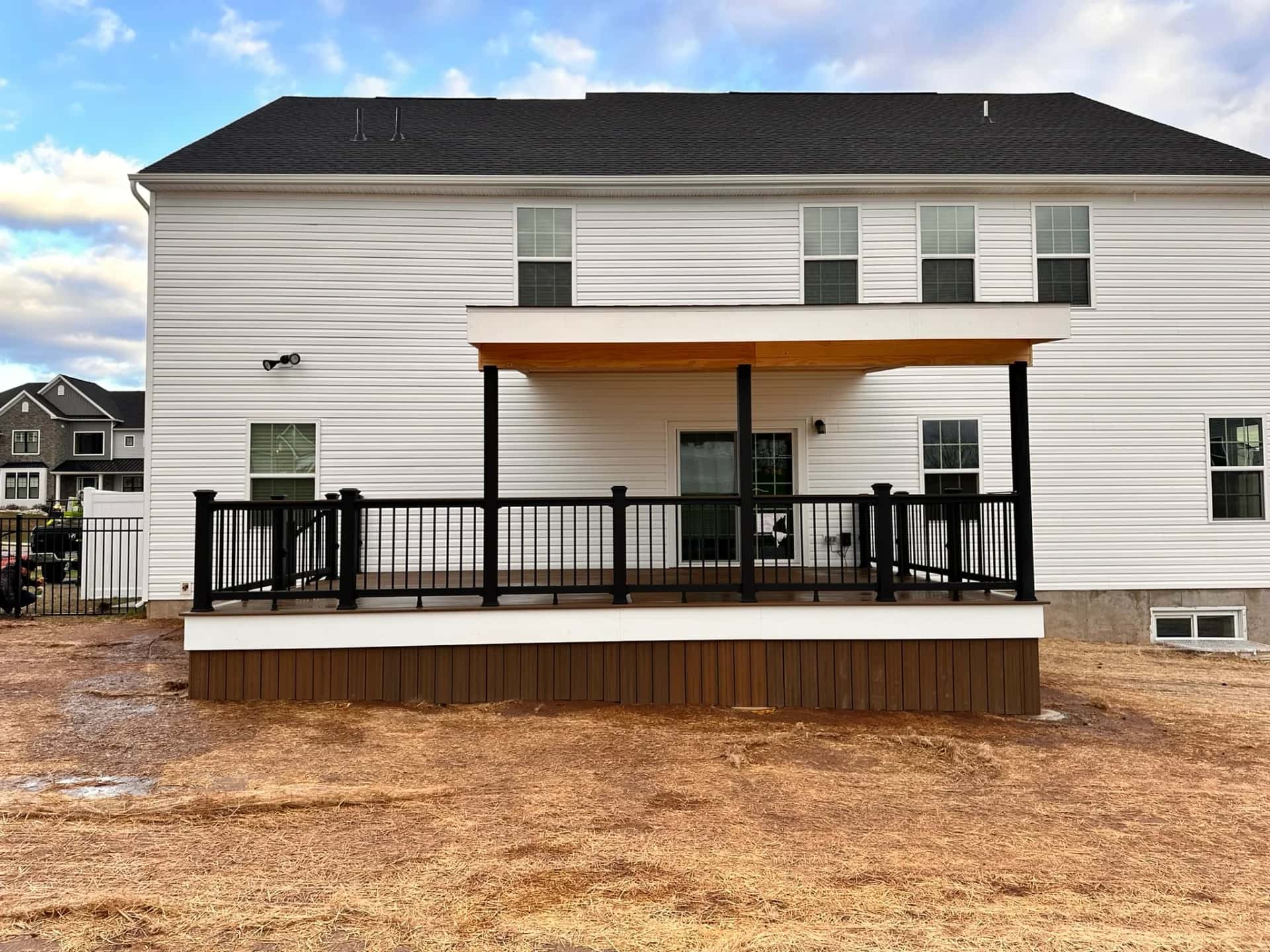 Multi-level composite deck with stairs and white railing