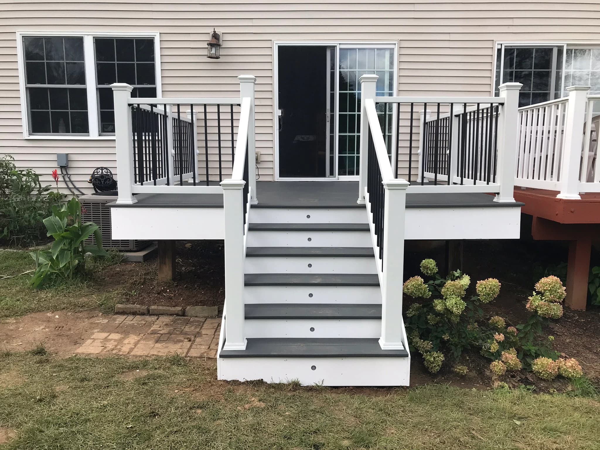 Straight stair and compact deck at the rear doorway.